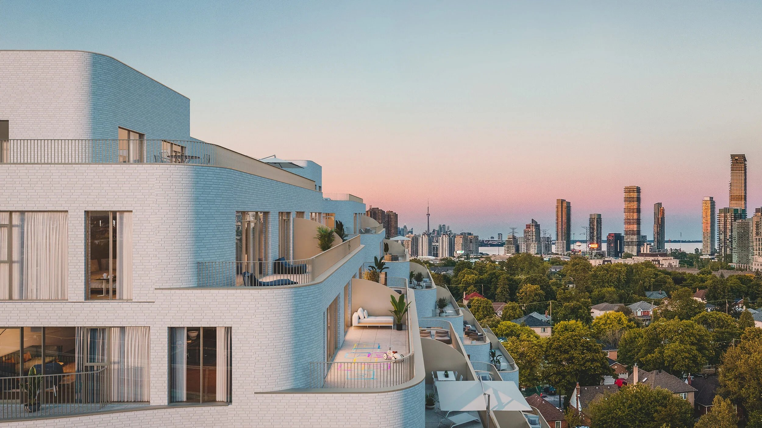 Reina Condos at 689 The Queensway In Etobicoke. A modern white brick apartment building with curved balconies, some decorated with plants and outdoor furniture, overlooking a city skyline with high-rise buildings and a tower at sunset.